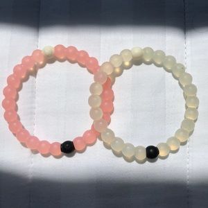 Pink and White Lokai bracelets